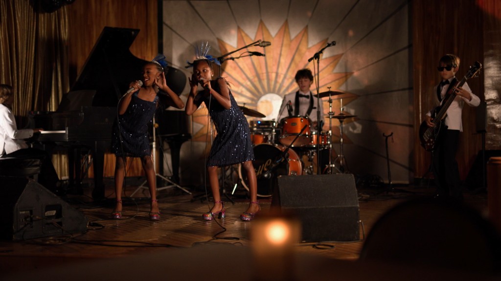 Young performers singing and playing on a jazz-club stage